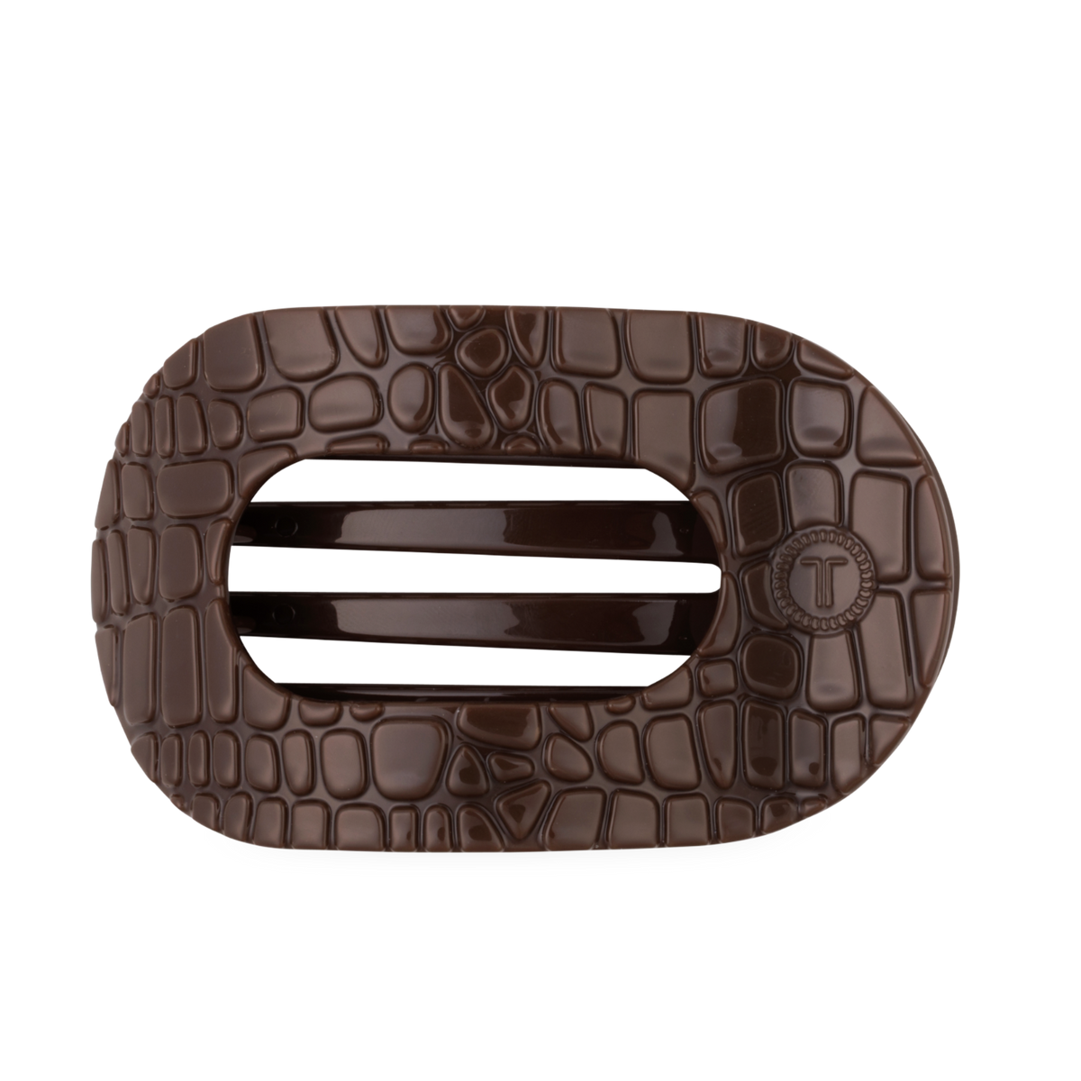 The Brown Crocodile Large Flat Round Hair Clip is a dark brown, oval accessory with a crocodile skin texture, two solid center bars, and a flat back for secure wear. Available in large size.