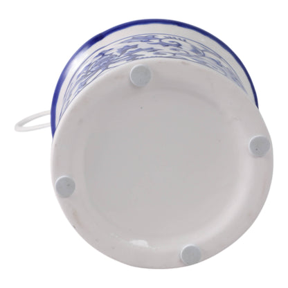 White/Blue 8x5 in. ceramic bird house bottom with four white pads for stability and a partially visible handle.