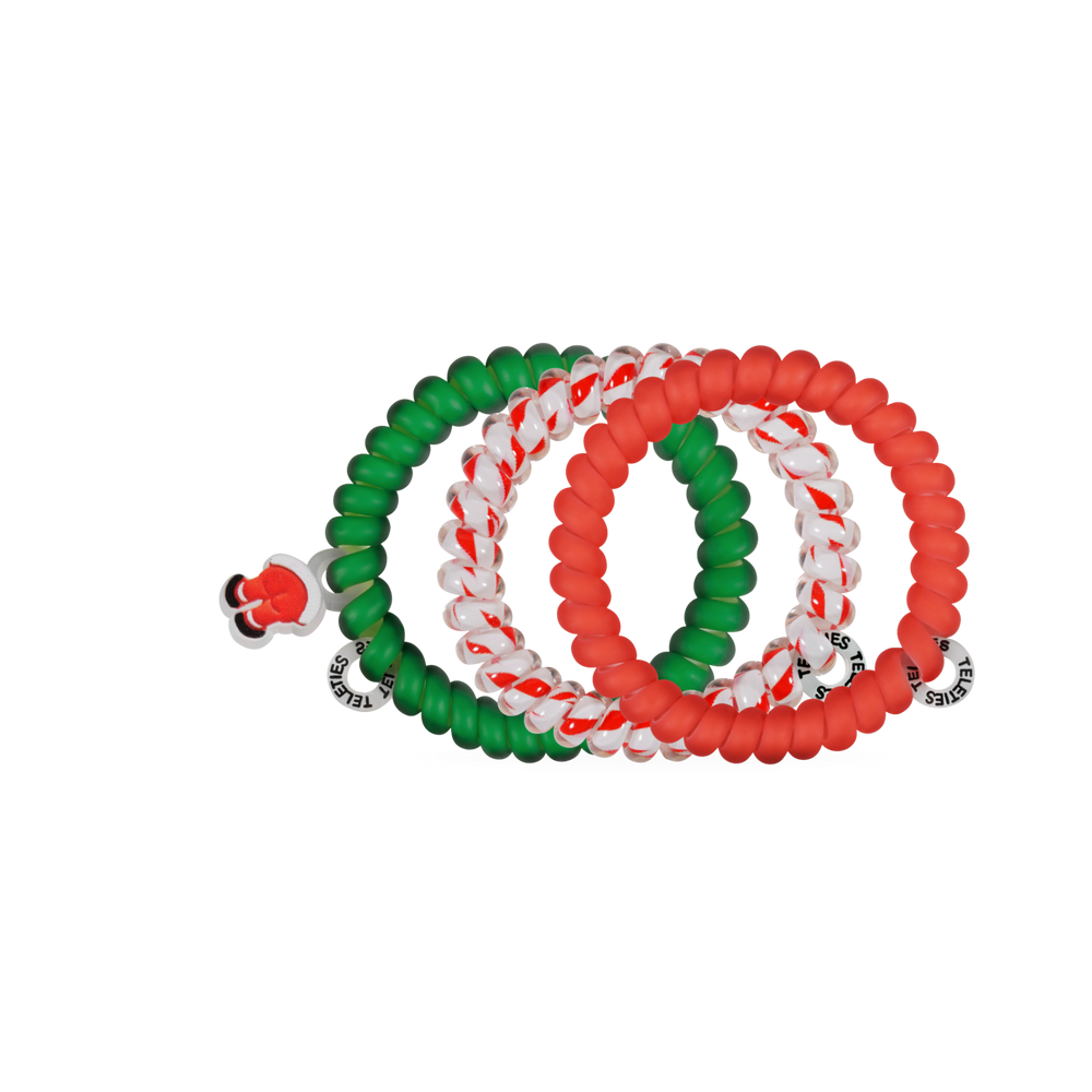 Claus I said So, Small hair ties: four holiday spiral coils in solid green, solid red, and red-and-white stripes, with one Santa hat charm.