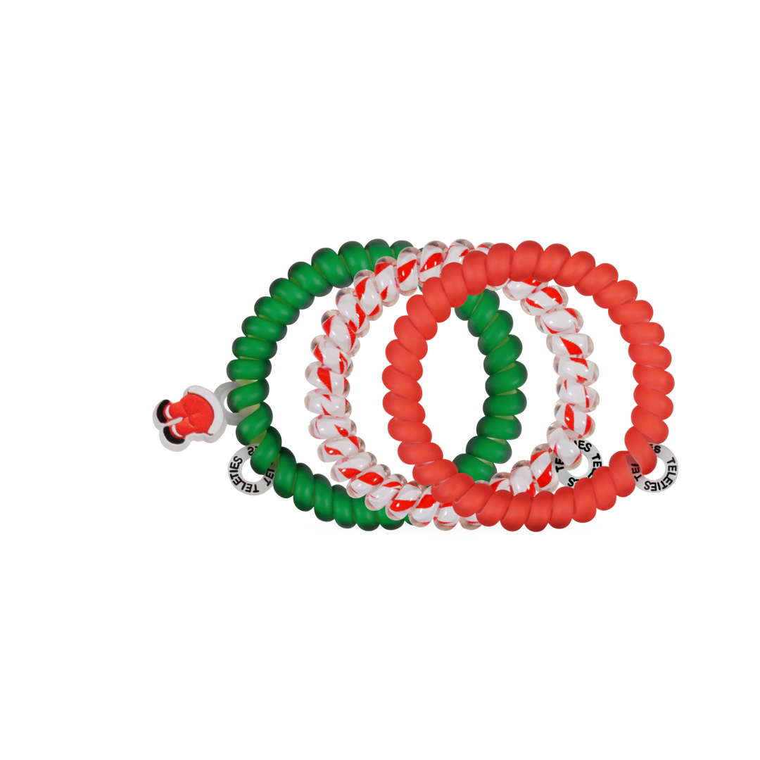 Claus I said So, Small hair ties: four holiday spiral coils in solid green, solid red, and red-and-white stripes, with one Santa hat charm.