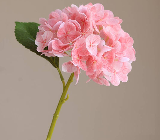 12.5" Real Touch lifelike Hydrangea with soft pink 6" bloom and green leaves; available in 12.5" size.
