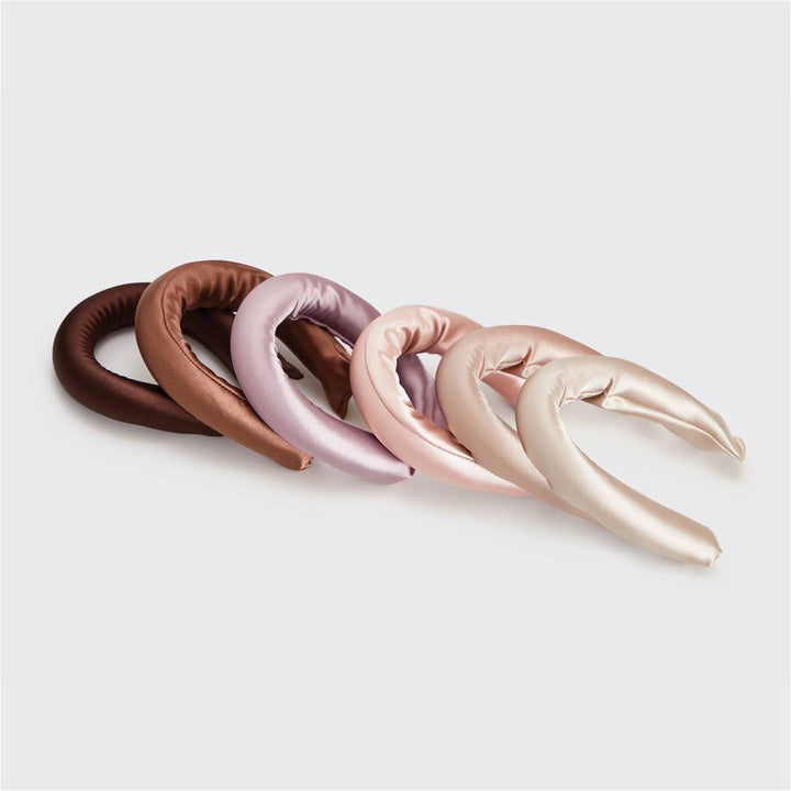 Six satin-wrapped flexi rods for heatless waves in brown, mauve, pink, and cream; available in multiple sizes.