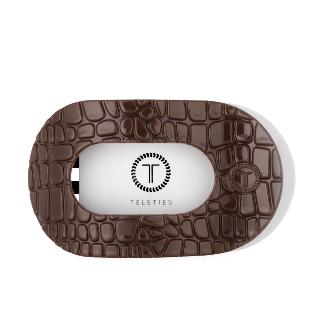 Brown Crocodile Large Flat Round Hair Clip with textured oval shape, crocodile skin pattern, and “T” logo with “TELETIES” in the center. Flat back for secure hold and comfort. Available in large size.