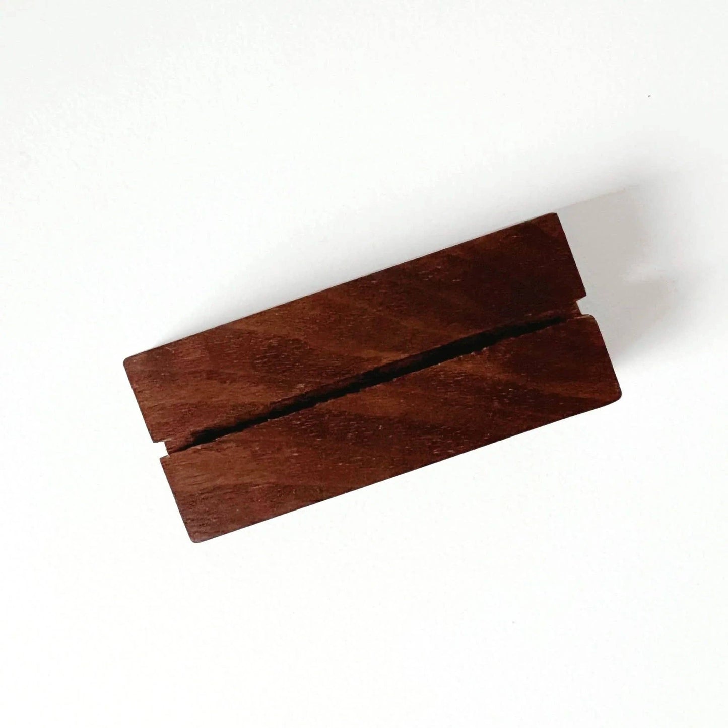 Rectangular walnut card holder with a center groove; available in small size.