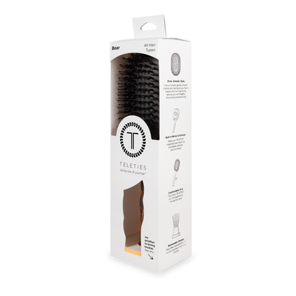 White box with clear window displaying black boar bristle hair brush; sizes available: small, medium, large.