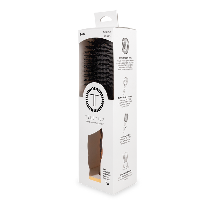 White box with clear window displaying black boar bristle hair brush; sizes available: small, medium, large.