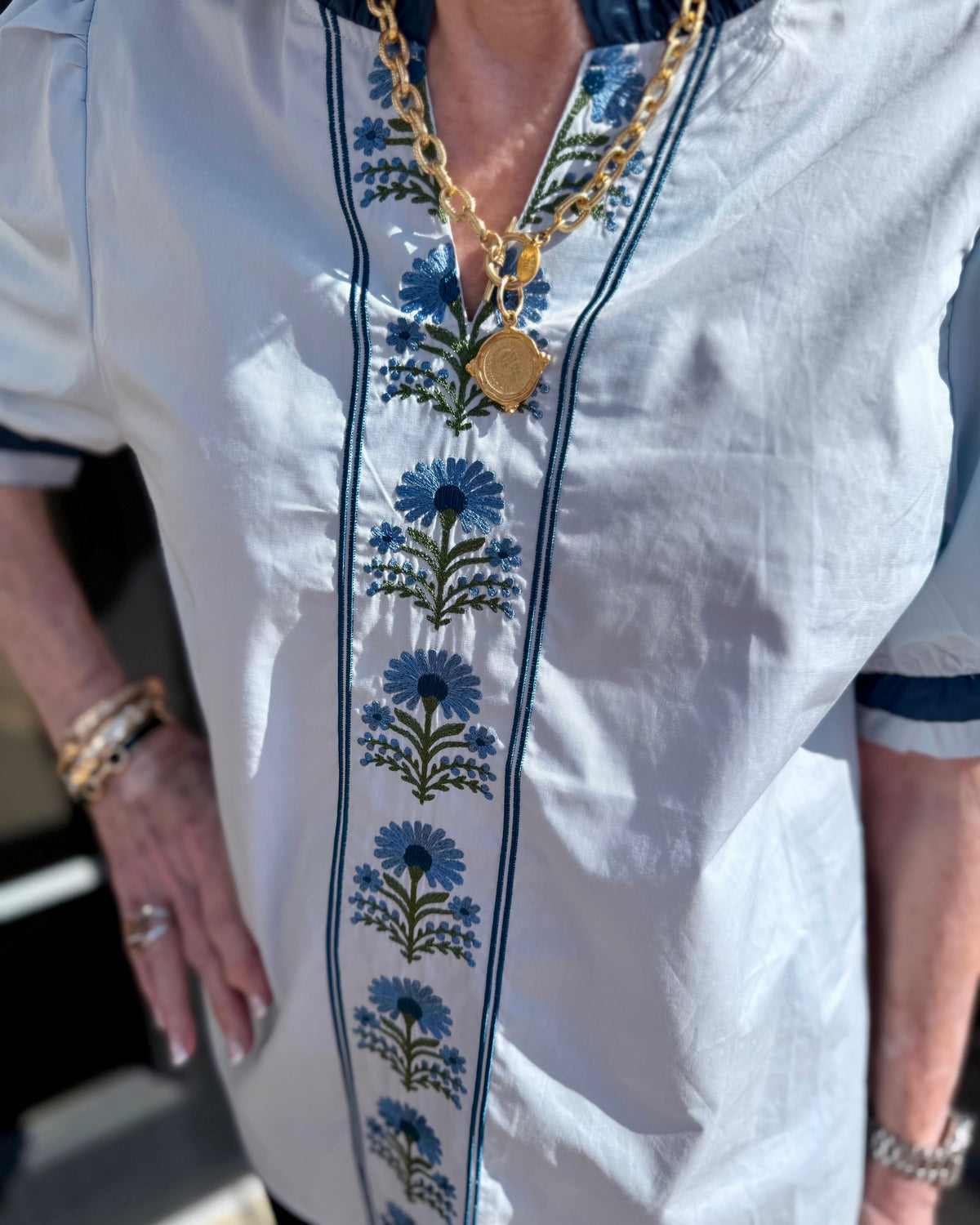 Bluebell Embroidered Blouse with blue floral embroidery and puff sleeves. Available in sizes XS-XL.