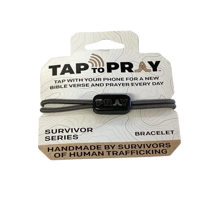 Tap To Pray Bracelet with elastic cord, black “PRAY” bead, and branded display card. Available in various sizes.