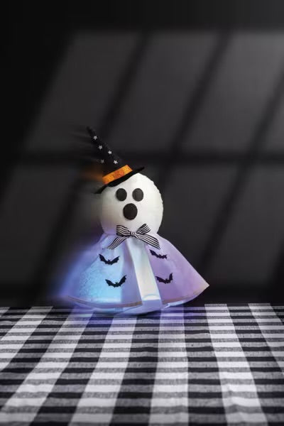 Ghost Motion Decor: cute ghost with black hat, bow tie, and skirt with black bat designs. Available in various sizes.