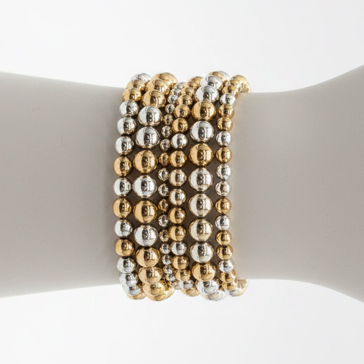 Hunter 6-Strand Stretch Bracelet Stack: six beaded stretch bracelets in alternating gold and silver metallic colors. Available sizes: small, medium, large.