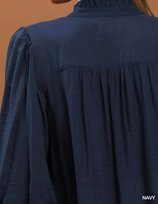 Navy Smocked Yoke Button Front Blouse with long sleeves, high collar, gathered back; available in sizes XS-XL.