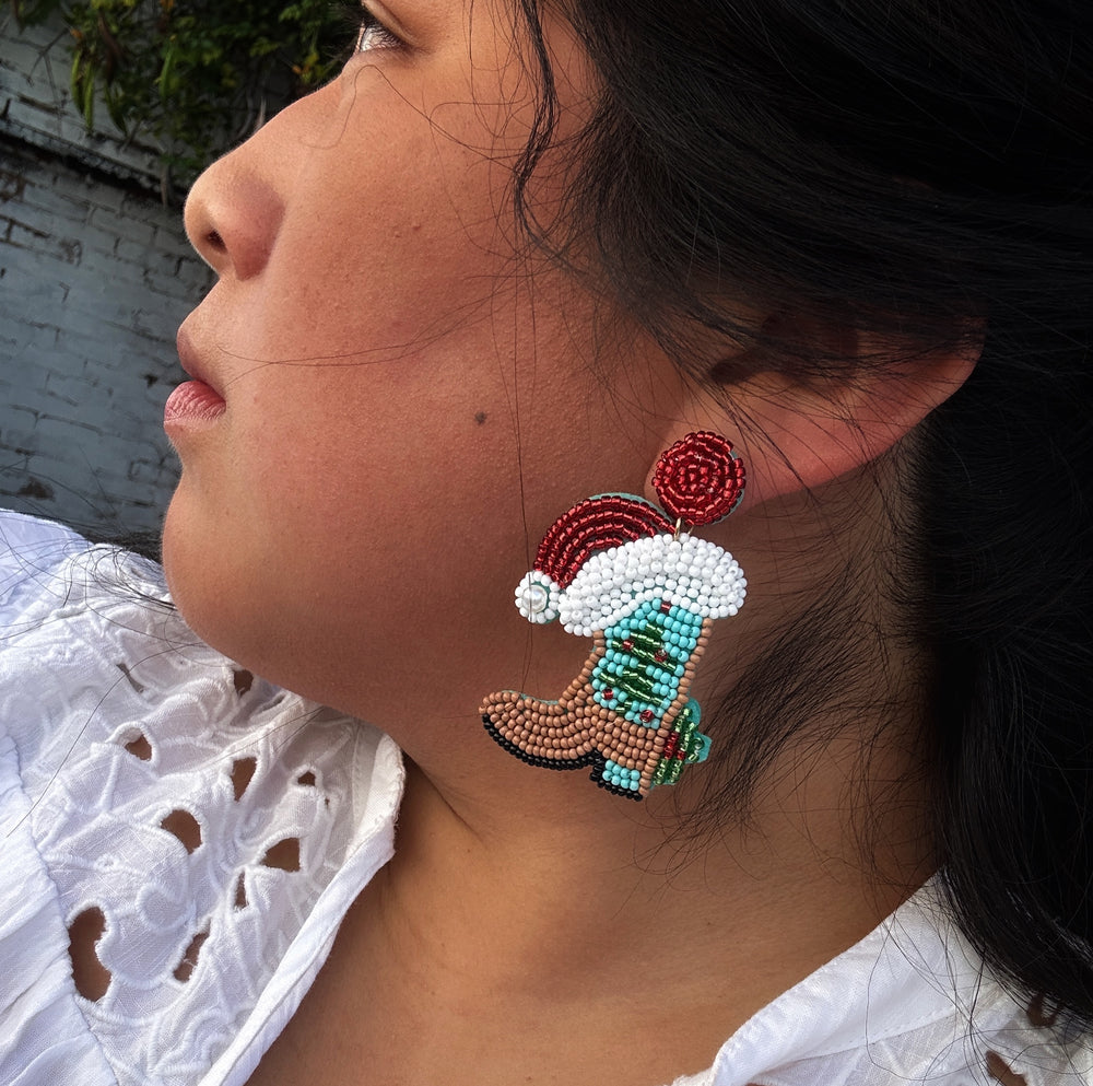 Beaded cowboy boot earrings with red and white Santa hats. Available in various sizes.