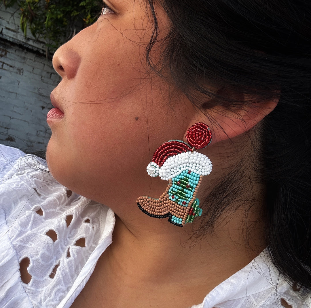 Beaded cowboy boot earrings with red and white Santa hats. Available in various sizes.