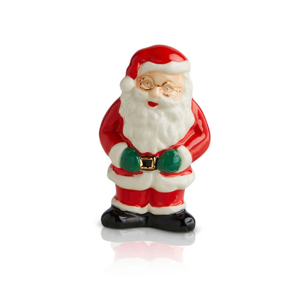 Nora Fleming Minis ceramic Santa figurine in red suit, black boots, green gloves, holding belt. Sizes available: mini.