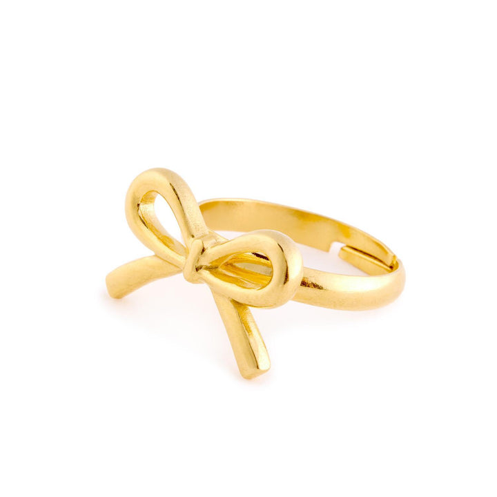 The Forget Me Not Ring is an adjustable gold ring with a delicate bow design, available in sizes 5-9.
