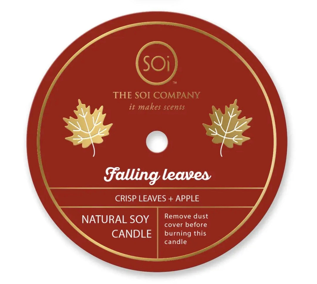 Round label for Happy Fall 12oz Icon Candle. Text includes brand name, fragrance description (crisp leaves + apple), and candle details (natural soy wax). Design features two gold leaves and a note to remove dust cover before use. Size available: 12oz.