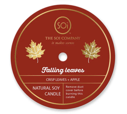 Round label for Happy Fall 12oz Icon Candle. Text includes brand name, fragrance description (crisp leaves + apple), and candle details (natural soy wax). Design features two gold leaves and a note to remove dust cover before use. Size available: 12oz.