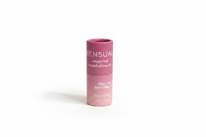 Pink cylindrical Keychain Mini Rollerball Perfume, "Sensual Sugared Sandalwood," alcohol-free; available in mini size.