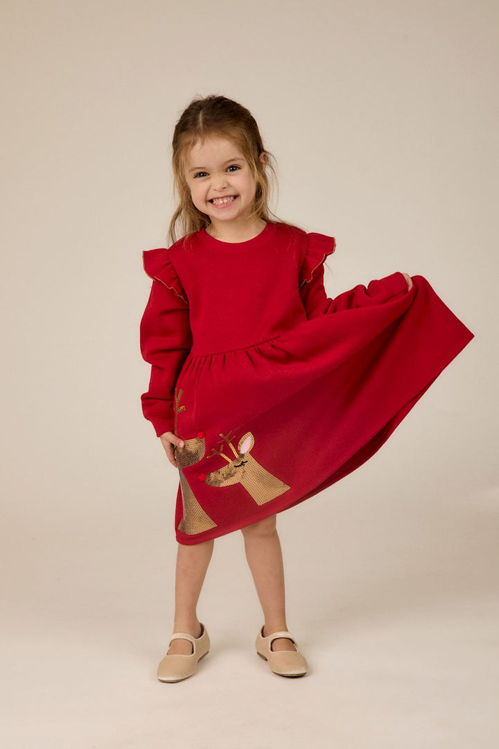 Red long-sleeve ruffle-shoulder dress with gold sequin reindeer skirt. Sizes available.