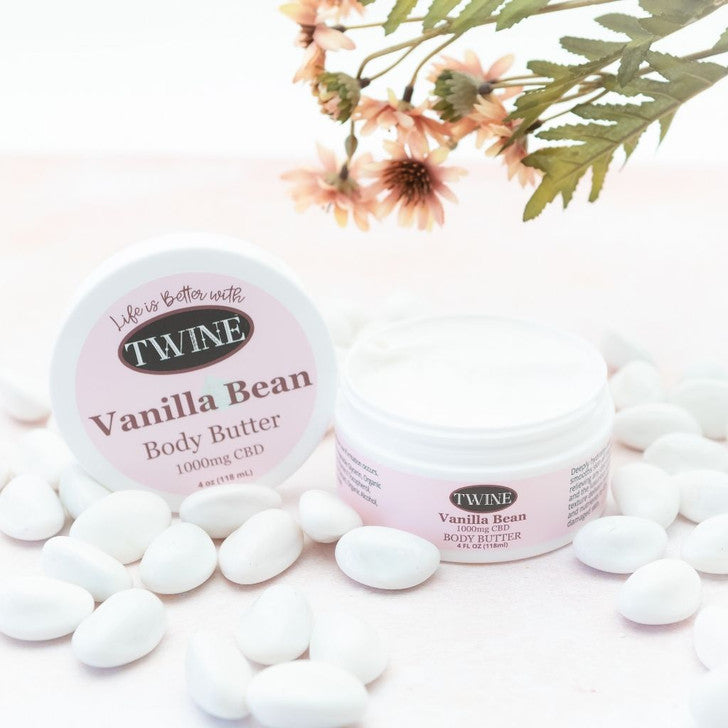 Open jar of Vanilla Bean Body Butter with pink label, 1000mg CBD, "Life is better with TWINE." Available in multiple sizes.