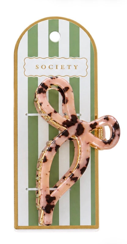 Pink and brown tortoiseshell metal bow claw clip; available in small and large sizes.