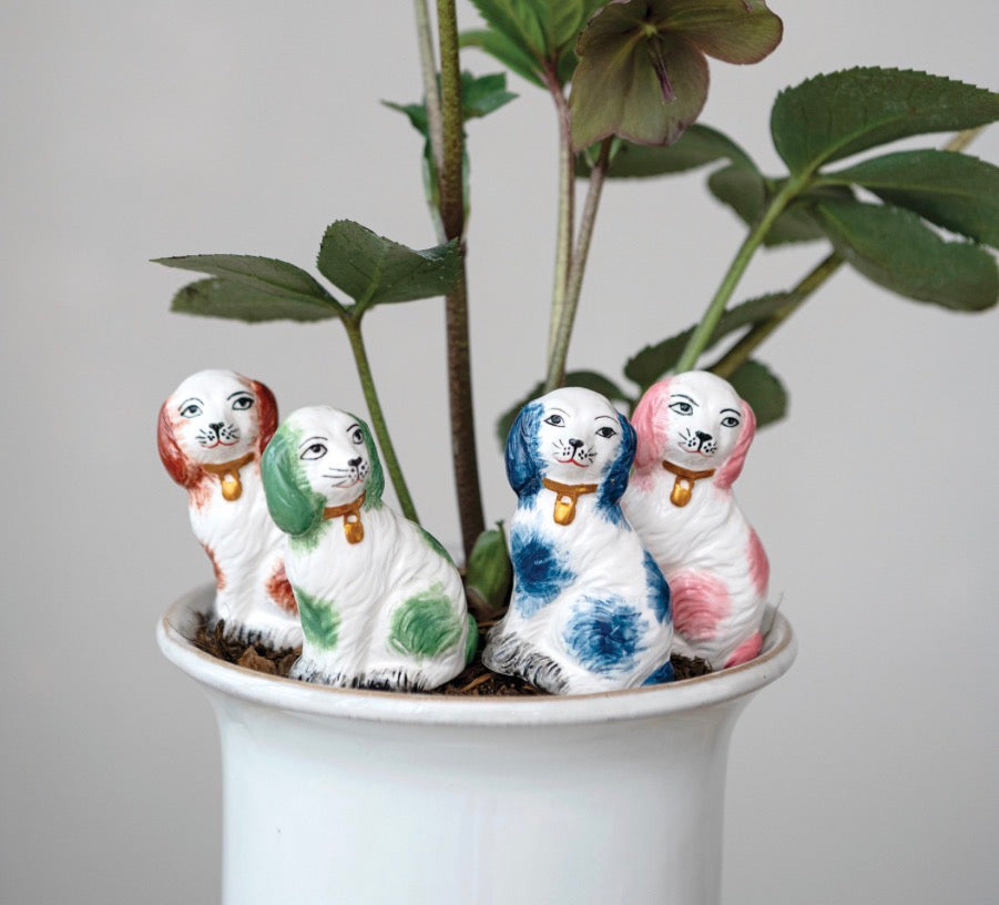 Set of four stoneware plant stake dog figurines with colored spots, available in multiple sizes.