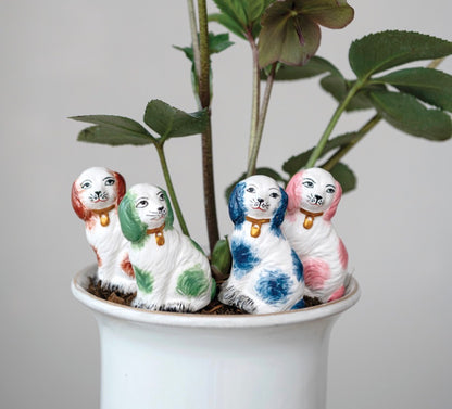 Set of four stoneware plant stake dog figurines with colored spots, available in multiple sizes.