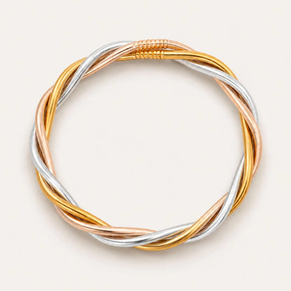Trilogy All Weather Bangle featuring twisted, interwoven strands of gold, silver, and rose gold with a seamless circular design and coiled accent at the top; available in multiple sizes.