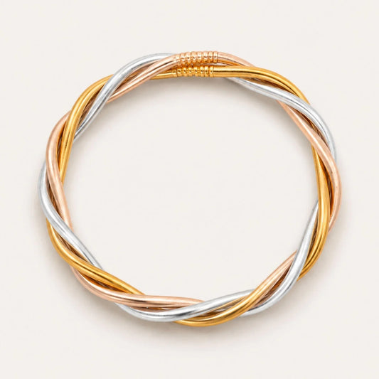 Trilogy All Weather Bangle featuring twisted, interwoven strands of gold, silver, and rose gold with a seamless circular design and coiled accent at the top; available in multiple sizes.