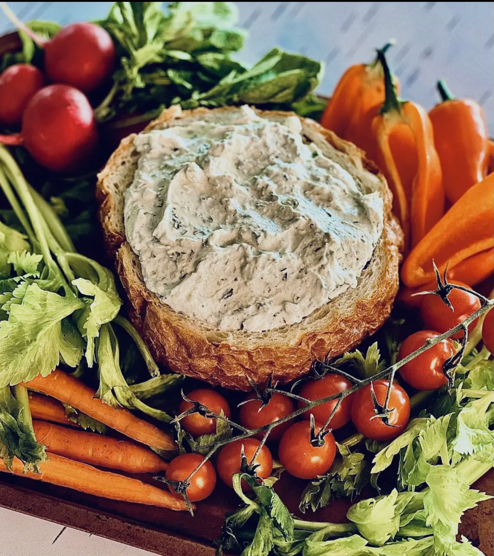 Bread bowl with Spinach Parmesan Dip and Cheeseball Mix. Available in small and large sizes.