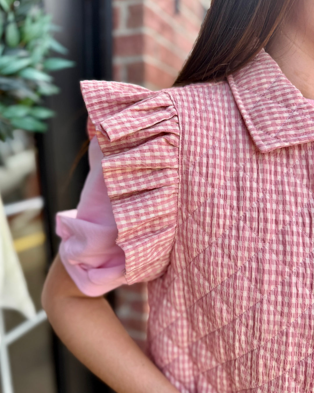 Blush Gingham Puffer Vest with pink and white checkered pattern, available in sizes XS-XL.
