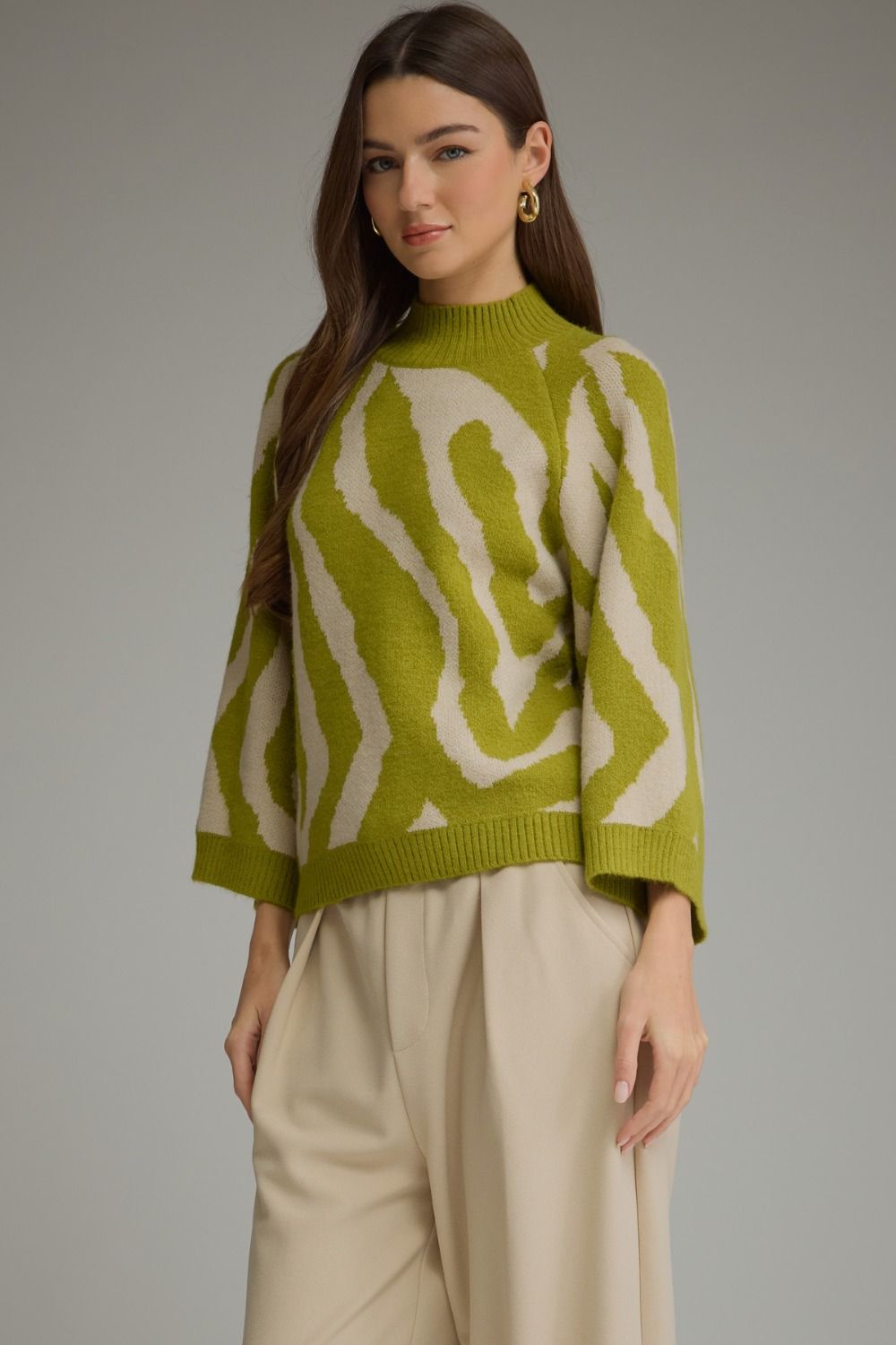 Olive green and beige zebra print mock neck sweater with three-quarter sleeves. Available in sizes.