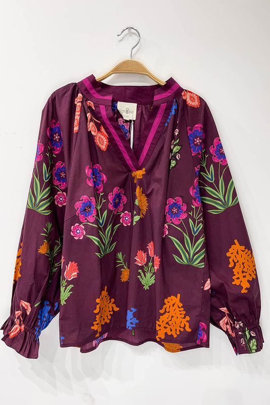 Burgundy Floral Mix Top: long sleeves, vibrant pink, orange, green, blue florals on deep purple. Available in sizes S-XL.