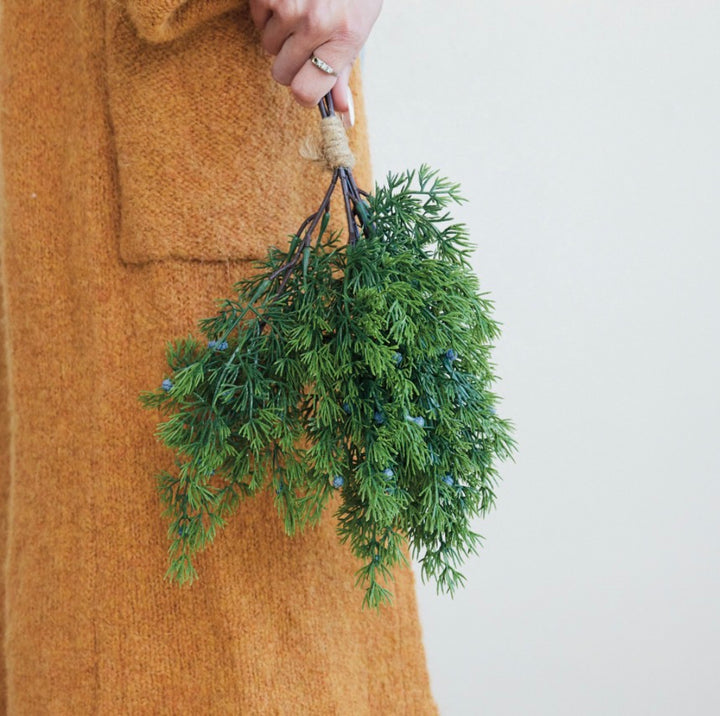Faux Pine Bundle of evergreen boughs tied with jute twine.