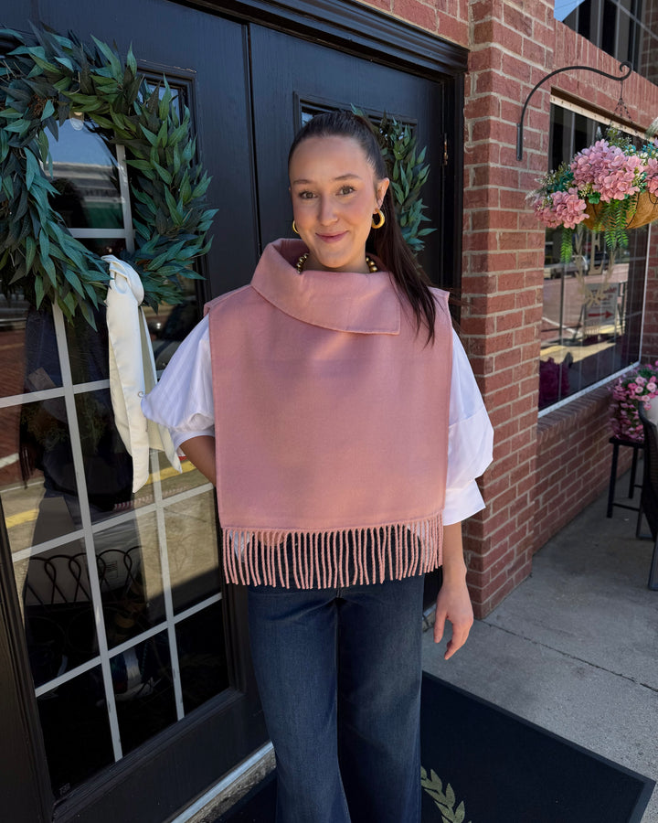 Blush pink cowl-neck poncho with fringe trim. Sizes available.