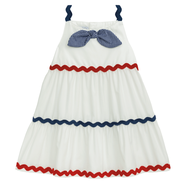 Sleeveless white dress with navy straps, blue gingham bow, red/navy ric rac trim. Sizes: 2T-6X.