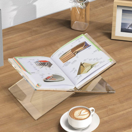 An Acrylic Book Stand with a feature to hold open textbooks with ease. This stand showcases colorfully printed pages and diagrams clearly while working or studying. Offers ample space for medium to large-sized books. Does not include textbook, coffee cup, or photo frame.