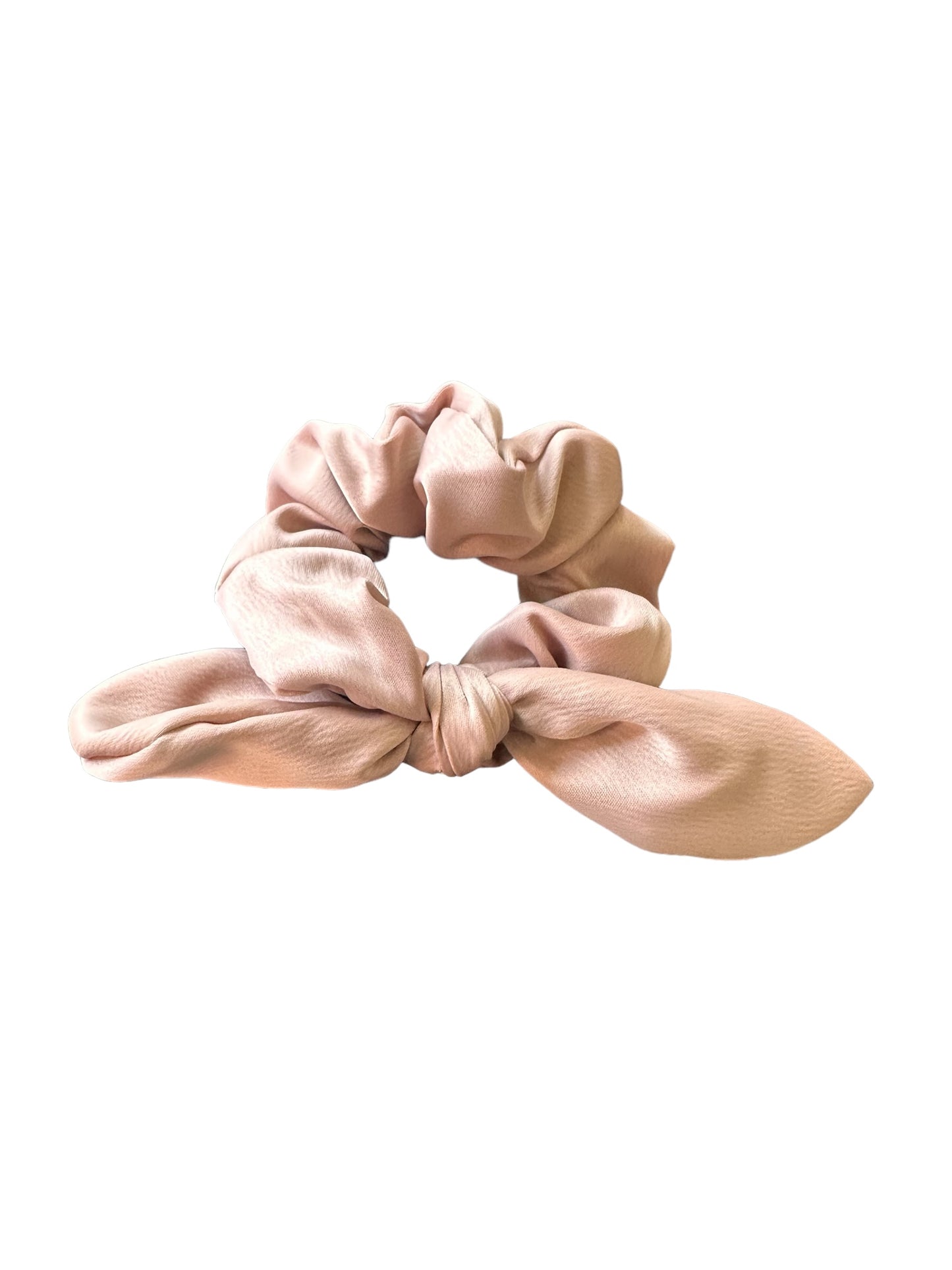 Light pink fabric Bow Scrunchie with a neat bow design on a gathered, elasticized band. Smooth, shiny material. Available size: One size fits most.