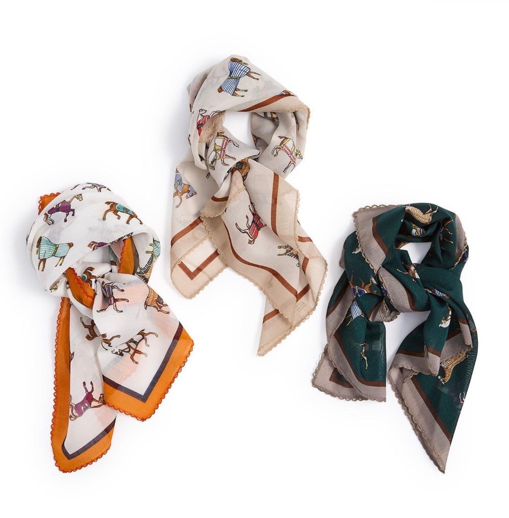 Three Horse Play Soft Square Scarves with equestrian animal prints are available in color combinations of white with orange, beige with brown, and dark green with gray. Available sizes: 35″x35″, 25″x25″.