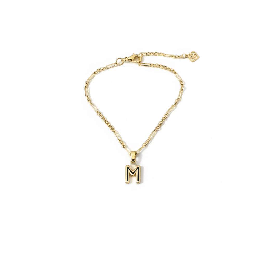 Gold chain bracelet with a gold and black "M" Bubble Letter Pendant charm. Available in small, medium, and large sizes.