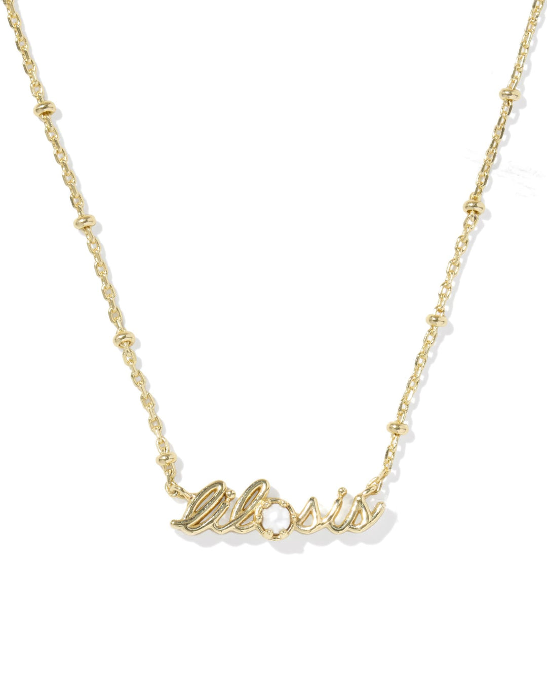 Gold Kendra Scott Lil Sis Necklace with “sister” script, gemstone accent; available in 16-18 inch adjustable chain.