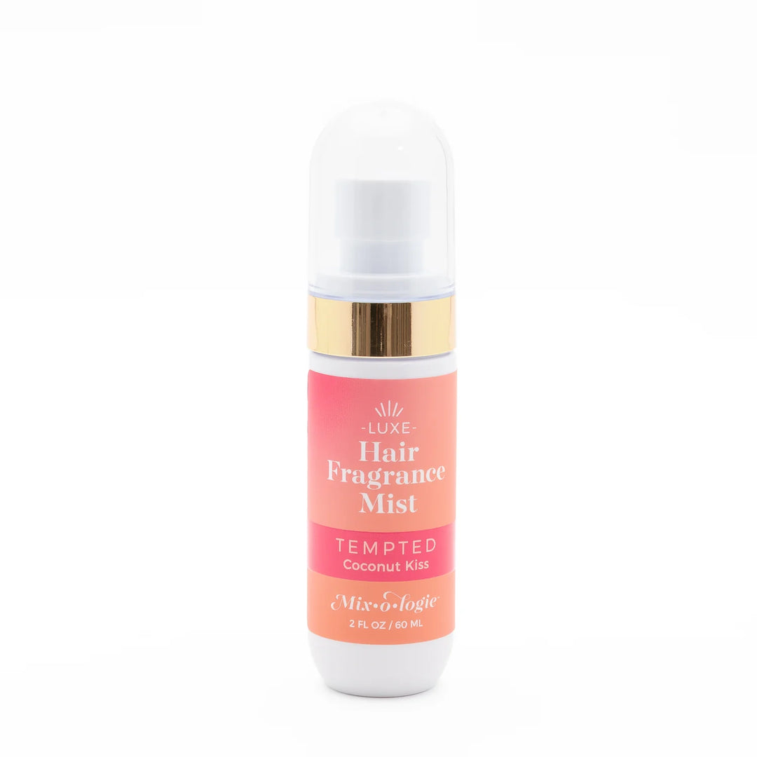 Mix O Logie Hair Fragrance Mist Tempted, 2 fl oz/60 mL, alcohol-free, tropical coconut scent, white spray top, pink-orange label.