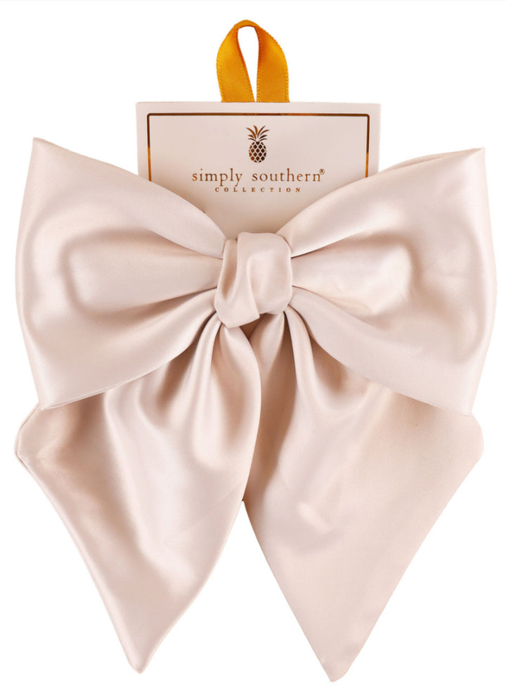 Large pale pink satin bow on “Simply Southern Collection” card with yellow hanging loop; available in large size.