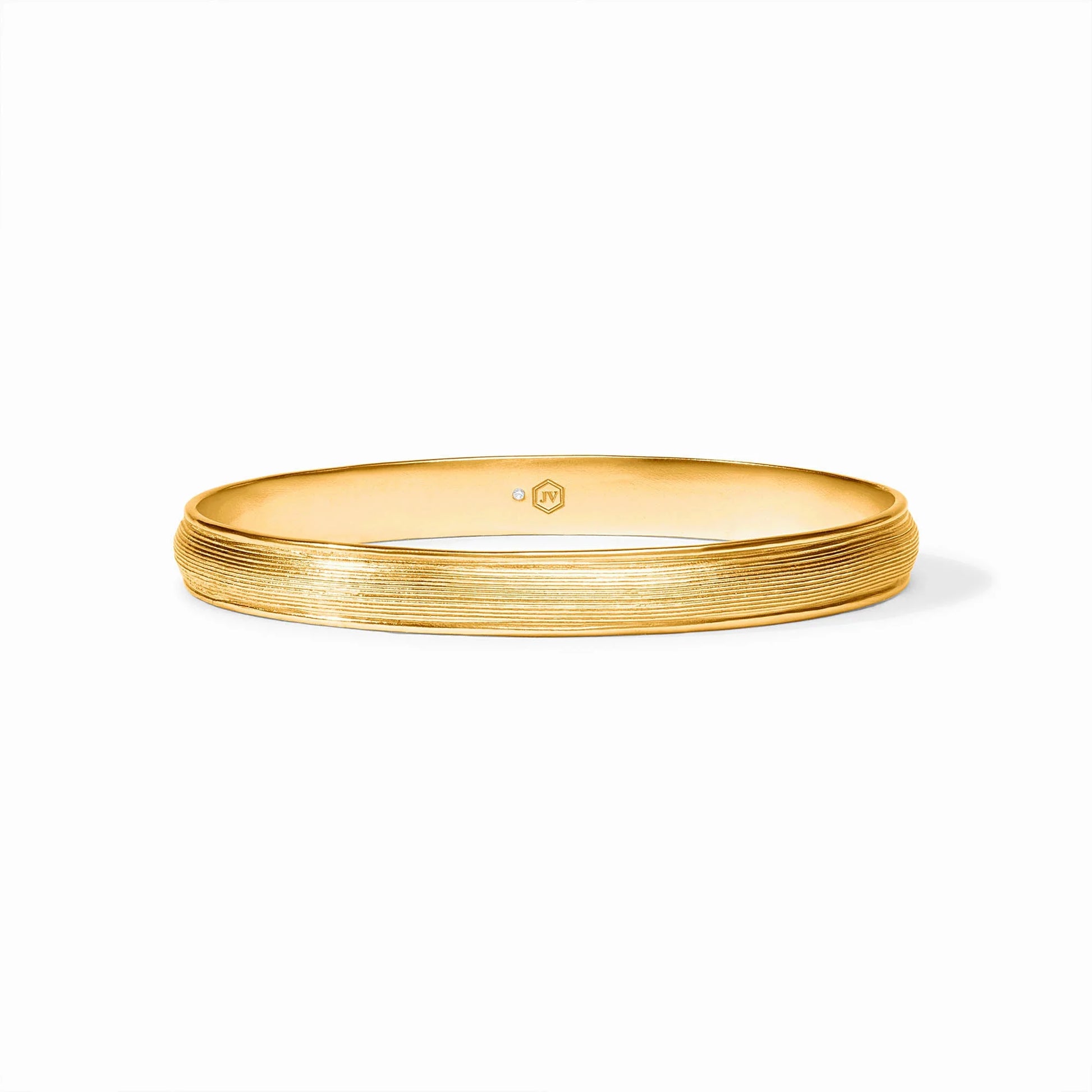 The Cobblestone Stacking Bangle has a textured 24K gold plate with a subtle ridged design on the outer surface. Available sizes: small, medium, large.
