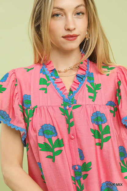 Floral Button Front Ruffle Sleeve Top: pink blouse with blue and green floral prints, ruffled sleeves with blue lace trim. Available in sizes XS–XXL.