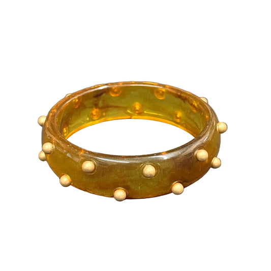 Translucent amber tortoise resin bangle with small gold round studs; available in multiple sizes.