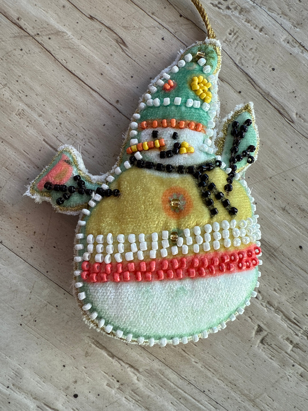 Cotton velvet snowman ornament with embroidery and glass beads.
