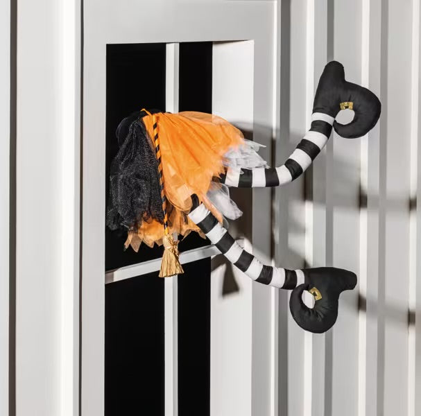Crashing Witches Legs Halloween decoration with striped legs and orange tutu-like skirt. Available in small, medium, and large sizes.