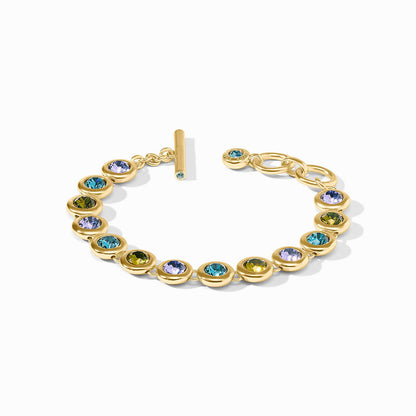 The Rainbow Tennis Bracelet | Blue Twilight: round bezel-set multicolored gems, 24K gold plate, toggle clasp, adjustable sizes.