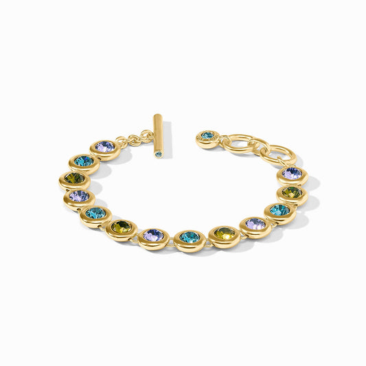 The Rainbow Tennis Bracelet | Blue Twilight: round bezel-set multicolored gems, 24K gold plate, toggle clasp, adjustable sizes.